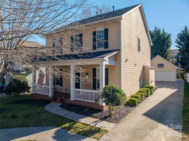 view of front of house featuring covered porch, an outdoor structure, and a detached garage