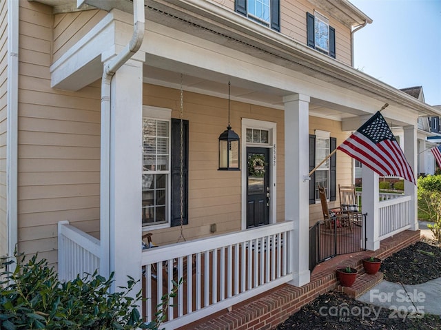 entrance to property featuring a porch