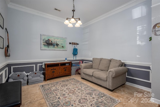 living area with visible vents, crown molding, wainscoting, tile patterned flooring, and an inviting chandelier