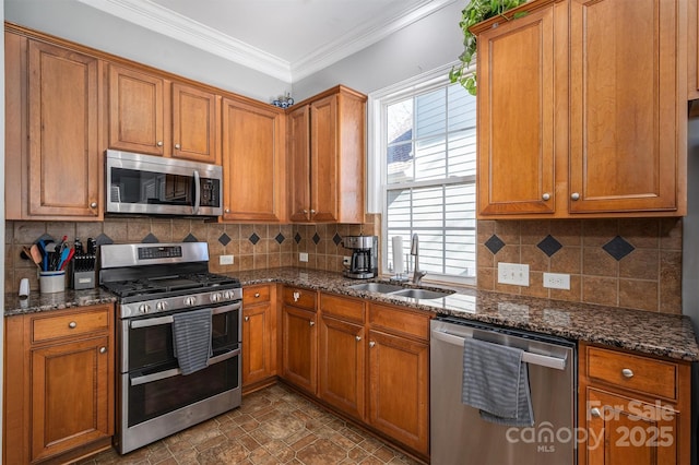 kitchen featuring brown cabinets, appliances with stainless steel finishes, and a sink