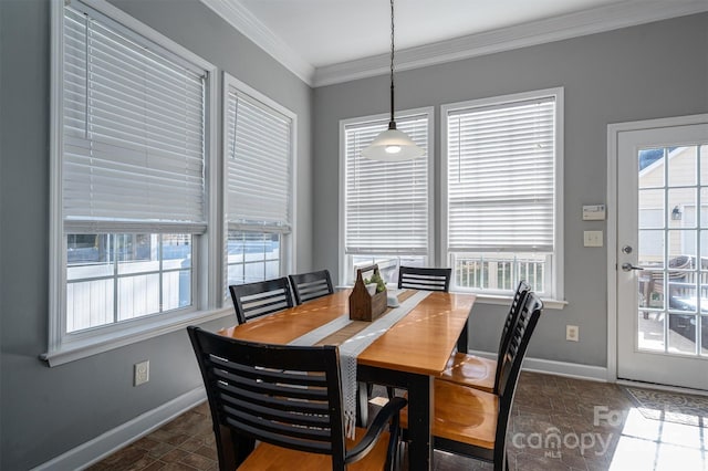 dining area featuring baseboards and crown molding