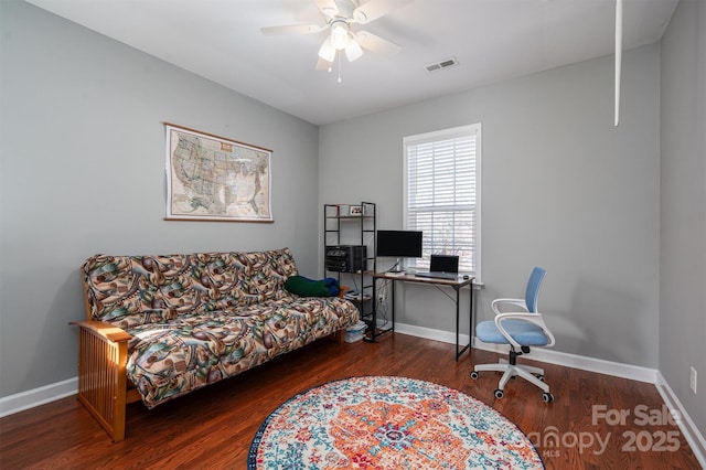 office space featuring visible vents, a ceiling fan, baseboards, and wood finished floors