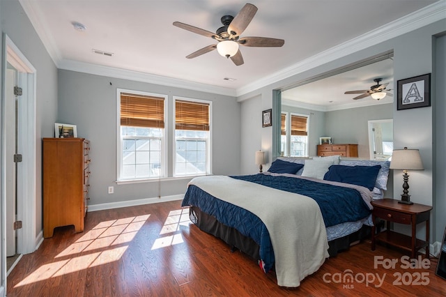 bedroom with ceiling fan, visible vents, wood finished floors, baseboards, and ornamental molding