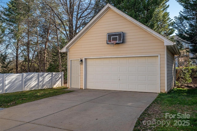 detached garage featuring fence