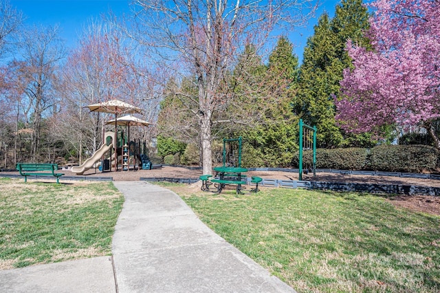 exterior space featuring a lawn and playground community
