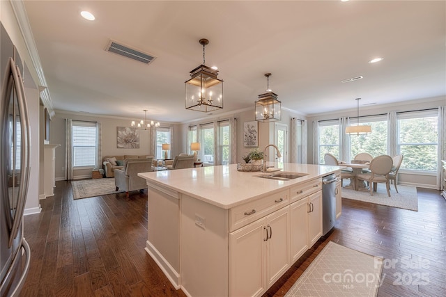 kitchen with visible vents, crown molding, a sink, an inviting chandelier, and stainless steel appliances