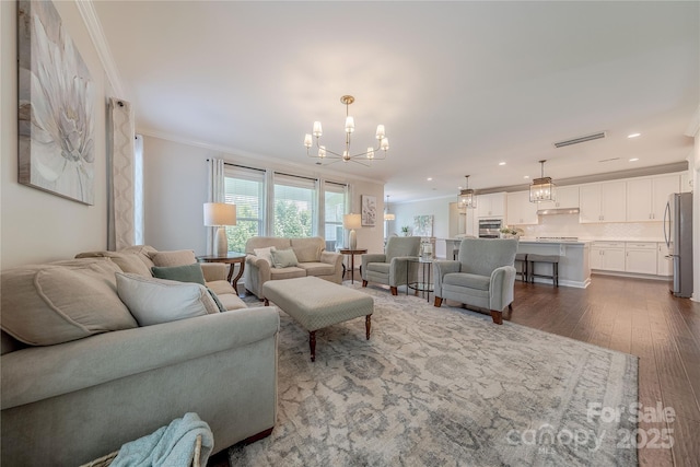 living room featuring a chandelier, dark wood finished floors, recessed lighting, visible vents, and ornamental molding