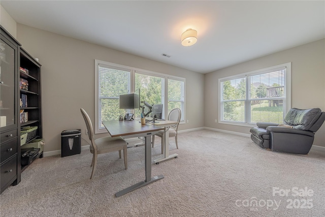 home office featuring baseboards, light colored carpet, and visible vents