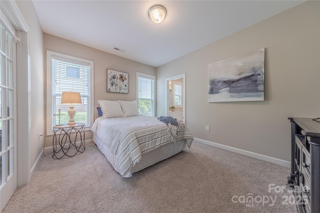 carpeted bedroom featuring baseboards and visible vents