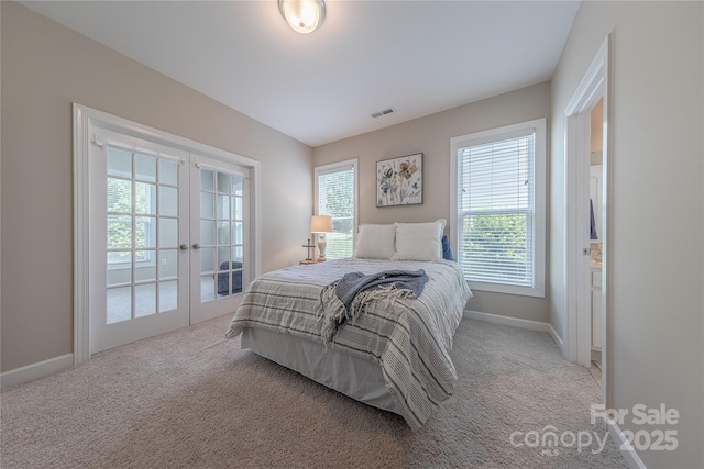 carpeted bedroom with baseboards, french doors, and visible vents