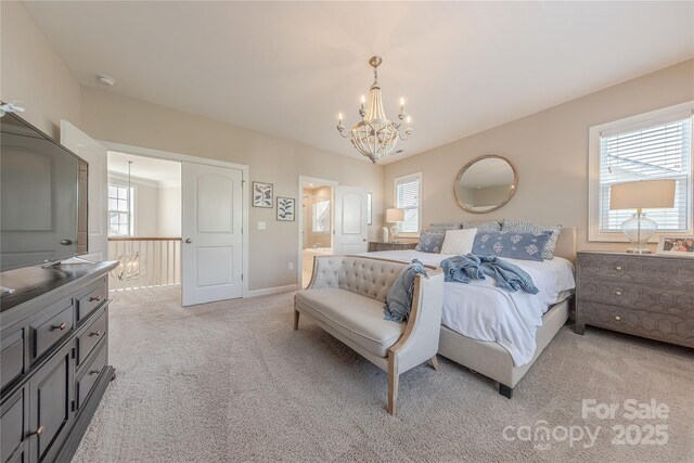 bedroom with an inviting chandelier, connected bathroom, baseboards, and light carpet