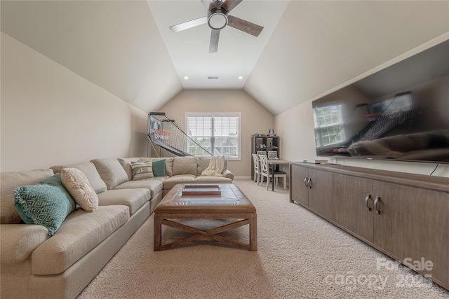 living area with visible vents, light carpet, baseboards, a ceiling fan, and vaulted ceiling
