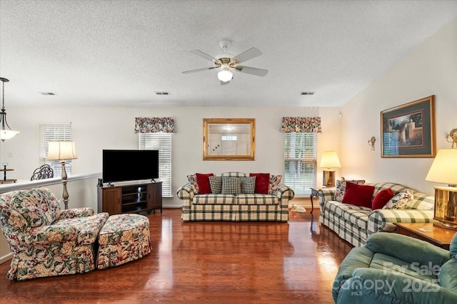 living room with ceiling fan, wood finished floors, and visible vents