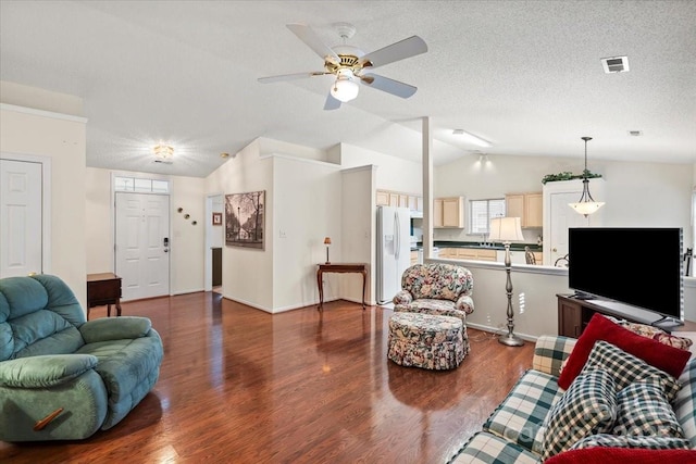 living area with ceiling fan, a textured ceiling, visible vents, dark wood finished floors, and lofted ceiling