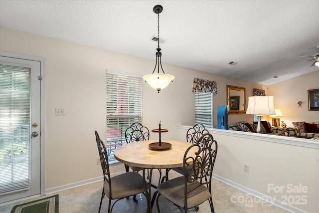 dining room with baseboards, visible vents, and a healthy amount of sunlight