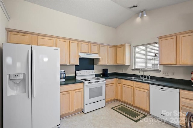 kitchen featuring light brown cabinets and white appliances