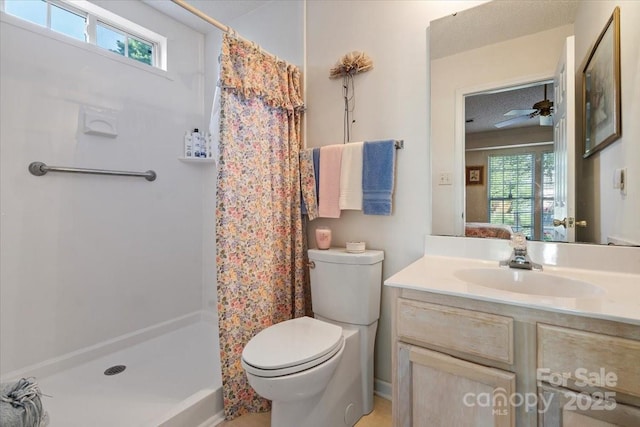 ensuite bathroom with a ceiling fan, a shower stall, vanity, toilet, and ensuite bathroom