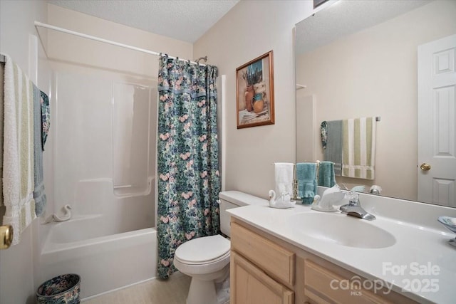 bathroom with vanity, toilet, a textured ceiling, and shower / tub combo