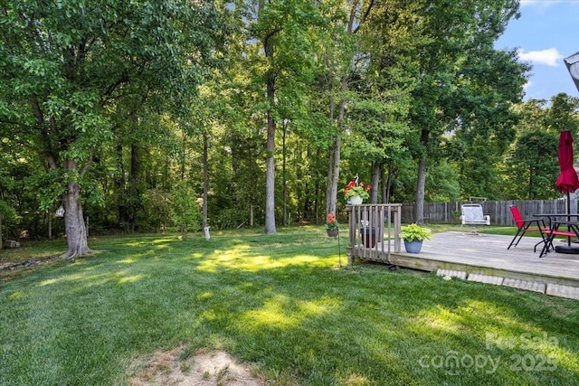 view of yard featuring fence and a deck