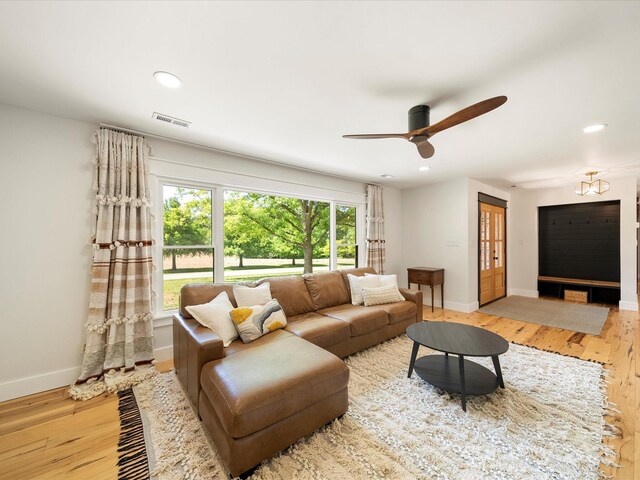 living area with ceiling fan, visible vents, wood finished floors, baseboards, and recessed lighting
