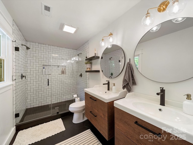 1207 Carlson Dr, Monroe, NC 28110 - full bath with a stall shower, two vanities, healthy amount of natural light, and tile patterned floors