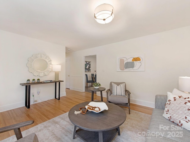living room with baseboards and light wood finished floors