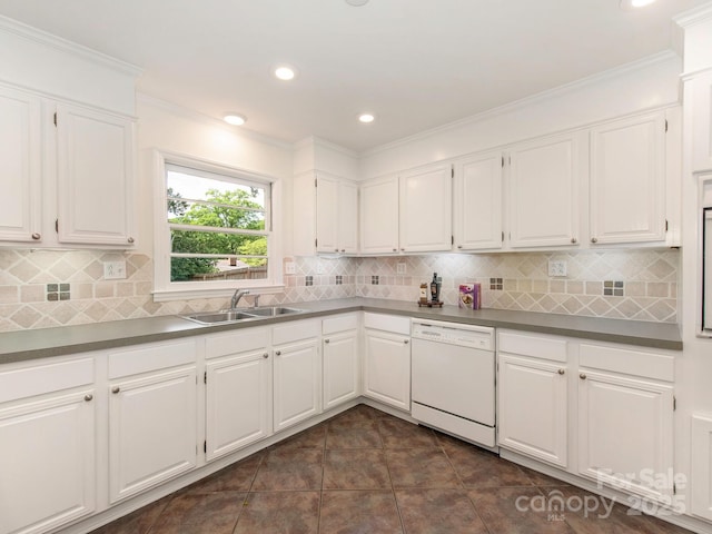 kitchen with white cabinets, ornamental molding, a sink, and dishwasher