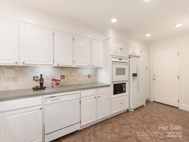 kitchen with white cabinetry, white appliances, and tasteful backsplash