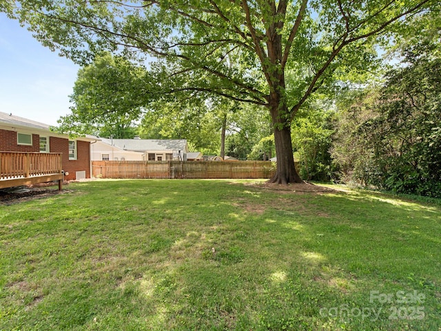 view of yard featuring fence and a wooden deck