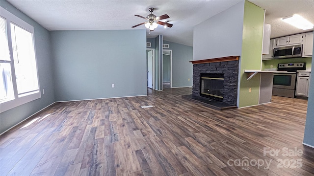 2844 Jamestown Rd Unit 2, Morganton, NC 28655 - unfurnished living room featuring plenty of natural light, dark wood-style flooring, a ceiling fan, a fireplace, and vaulted ceiling