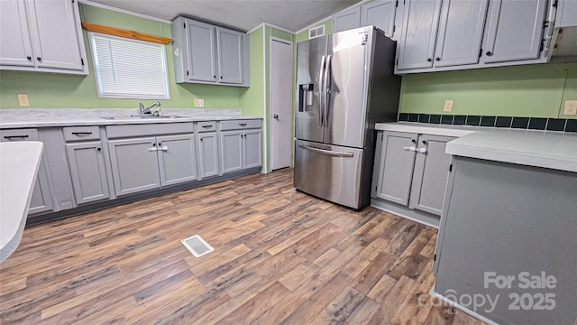 2844 Jamestown Rd Unit 2, Morganton, NC 28655 - kitchen with stainless steel fridge, a sink, wood finished floors, light countertops, and a textured ceiling