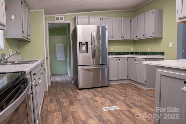 2844 Jamestown Rd Unit 2, Morganton, NC 28655 - kitchen with appliances with stainless steel finishes, wood finished floors, a sink, light countertops, and ornamental molding