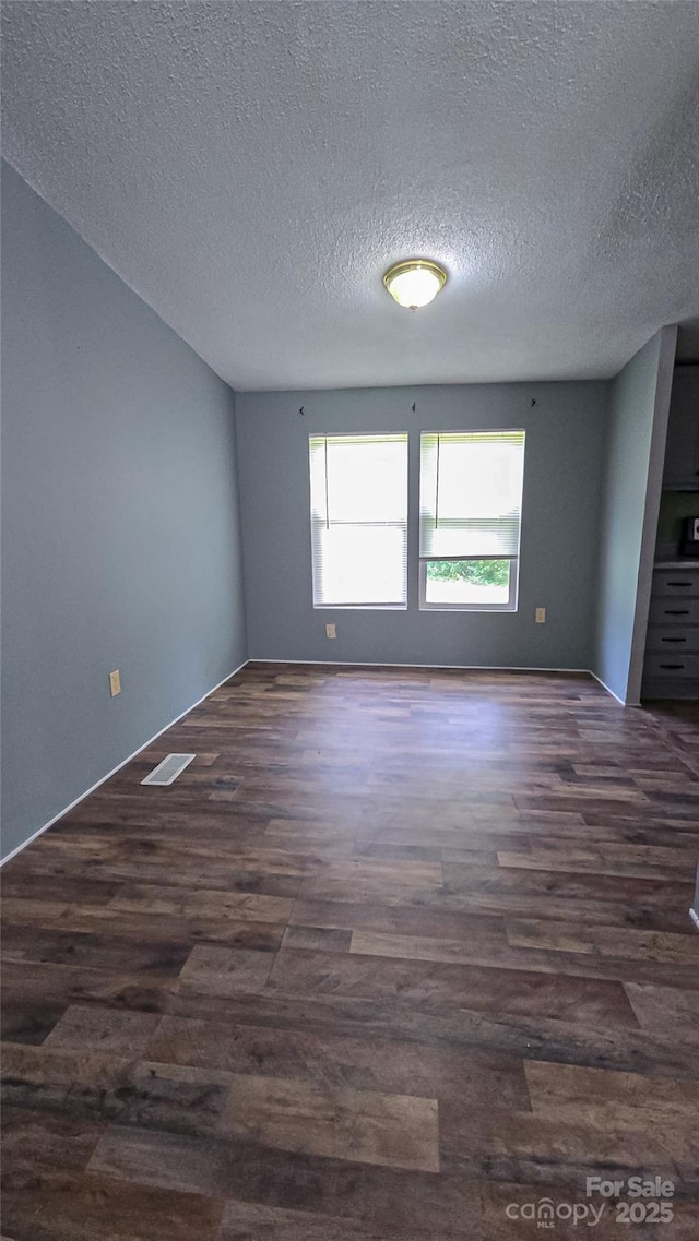 2844 Jamestown Rd Unit 2, Morganton, NC 28655 - spare room with dark wood-type flooring and a textured ceiling