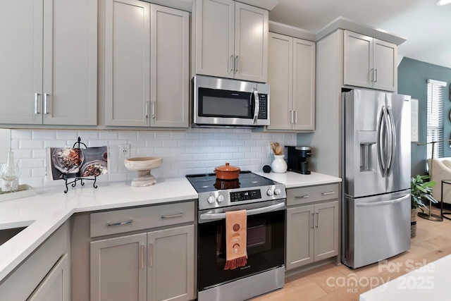 316 S Turner Ave Unit 11, Charlotte, NC 28208 - kitchen featuring appliances with stainless steel finishes, gray cabinetry, and tasteful backsplash
