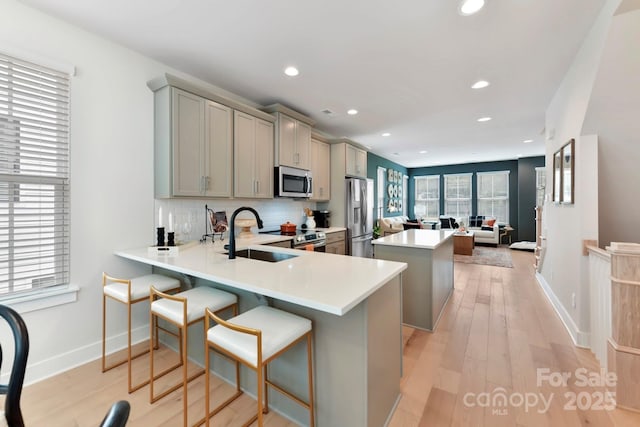 316 S Turner Ave Unit 11, Charlotte, NC 28208 - kitchen with gray cabinets, appliances with stainless steel finishes, a center island, a sink, and recessed lighting
