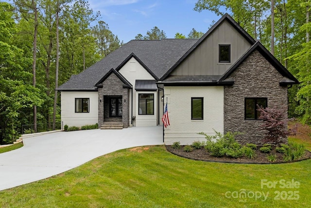 view of front facade with a front lawn, board and batten siding, stone siding, and concrete driveway
