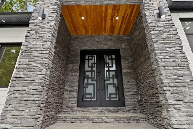 doorway to property with stone siding