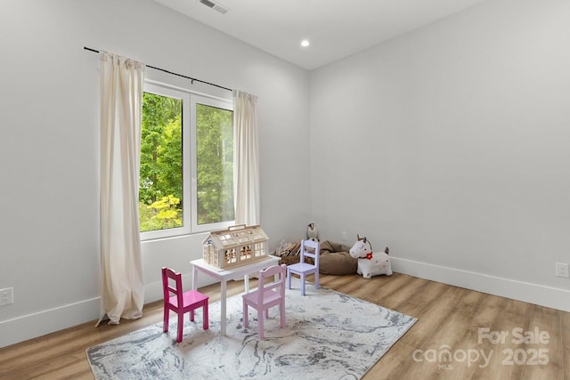 game room with baseboards, recessed lighting, wood finished floors, and visible vents