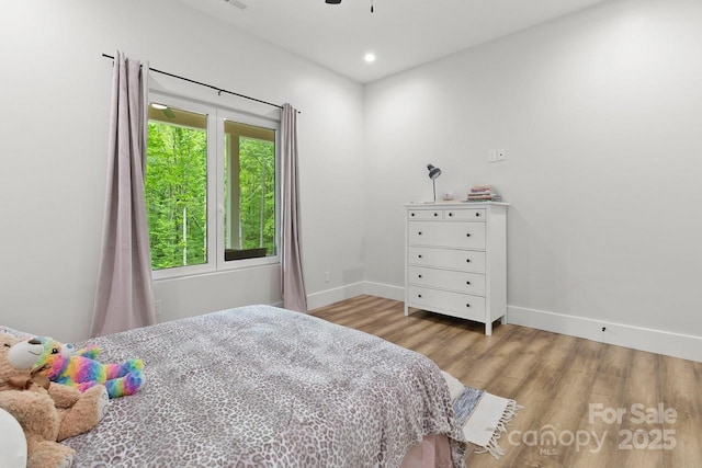 bedroom featuring baseboards, recessed lighting, a ceiling fan, and wood finished floors