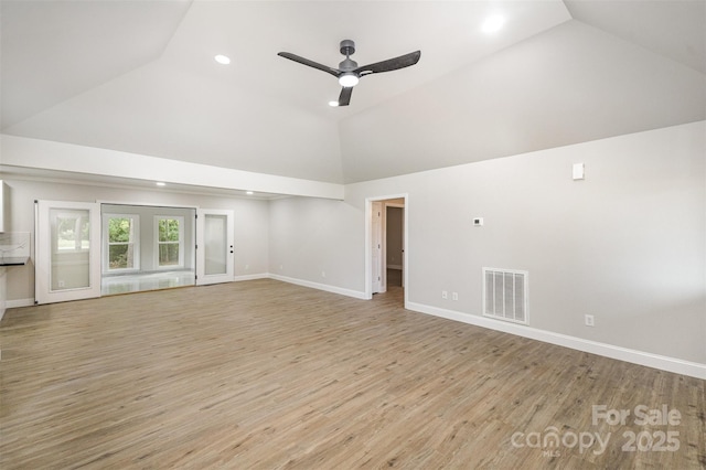 unfurnished living room featuring high vaulted ceiling, visible vents, ceiling fan, and light wood-style floors