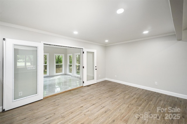 spare room with crown molding, french doors, recessed lighting, baseboards, and wood finished floors