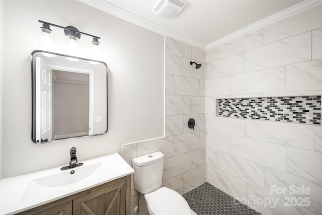 full bathroom with visible vents, crown molding, a tile shower, vanity, and toilet