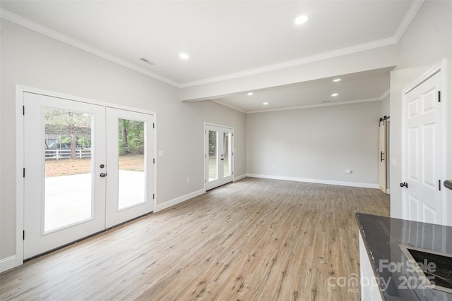 unfurnished living room with french doors, recessed lighting, visible vents, and light wood-type flooring