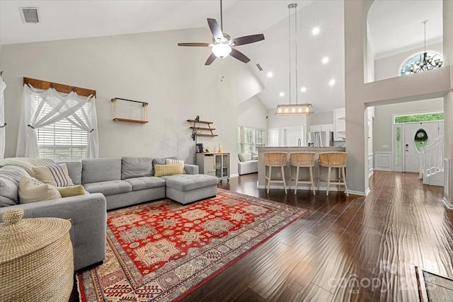 living area with high vaulted ceiling, dark wood finished floors, plenty of natural light, and ceiling fan