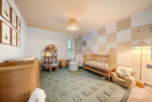 bedroom with carpet flooring and a nursery area