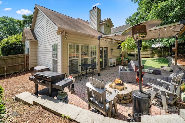 view of patio featuring a fire pit, a fenced backyard, and area for grilling