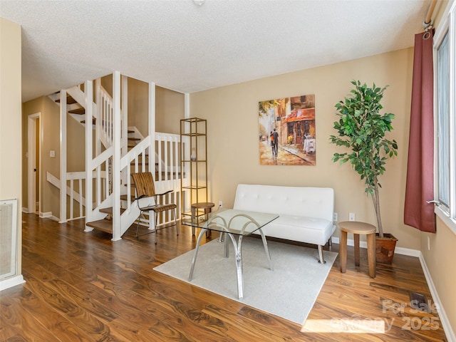 23 Hollybrook Dr, Asheville, NC 28803 - sitting room with stairs, a textured ceiling, baseboards, and wood finished floors