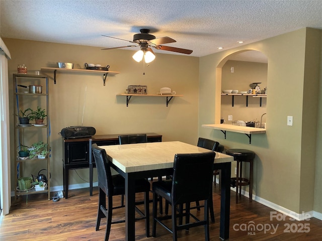 23 Hollybrook Dr, Asheville, NC 28803 - dining area featuring a textured ceiling, baseboards, a ceiling fan, and wood finished floors