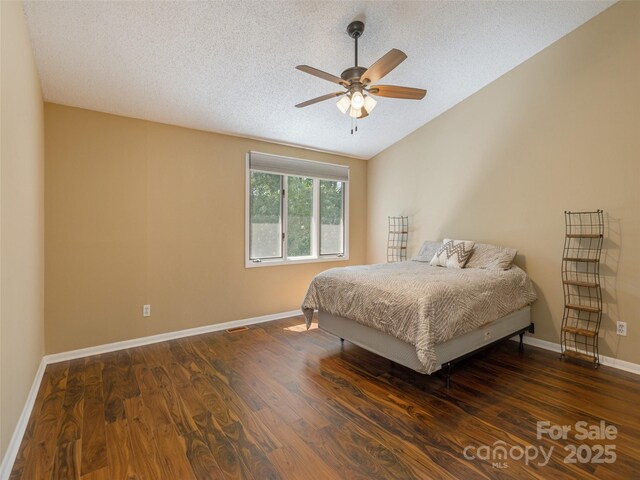 23 Hollybrook Dr, Asheville, NC 28803 - bedroom with baseboards, a textured ceiling, vaulted ceiling, and wood finished floors