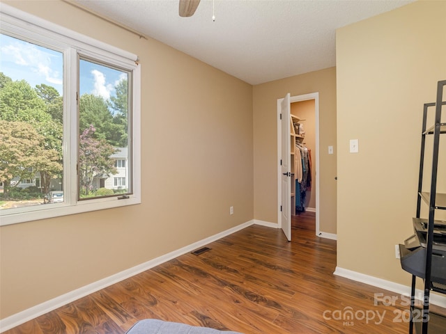 23 Hollybrook Dr, Asheville, NC 28803 - unfurnished bedroom featuring ceiling fan, visible vents, wood finished floors, baseboards, and a spacious closet